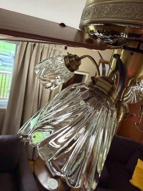 Cut-glass light shades washed by hand and rehung on a Mendoza job