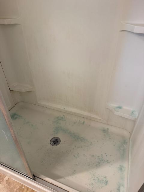 Shower pan, limescale lifted — before cleaning