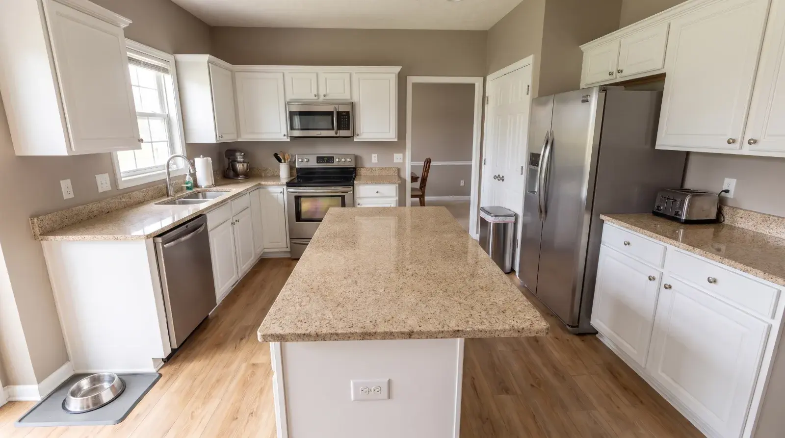 A deep-cleaned kitchen in a Columbus family home, counters bare and appliances polished