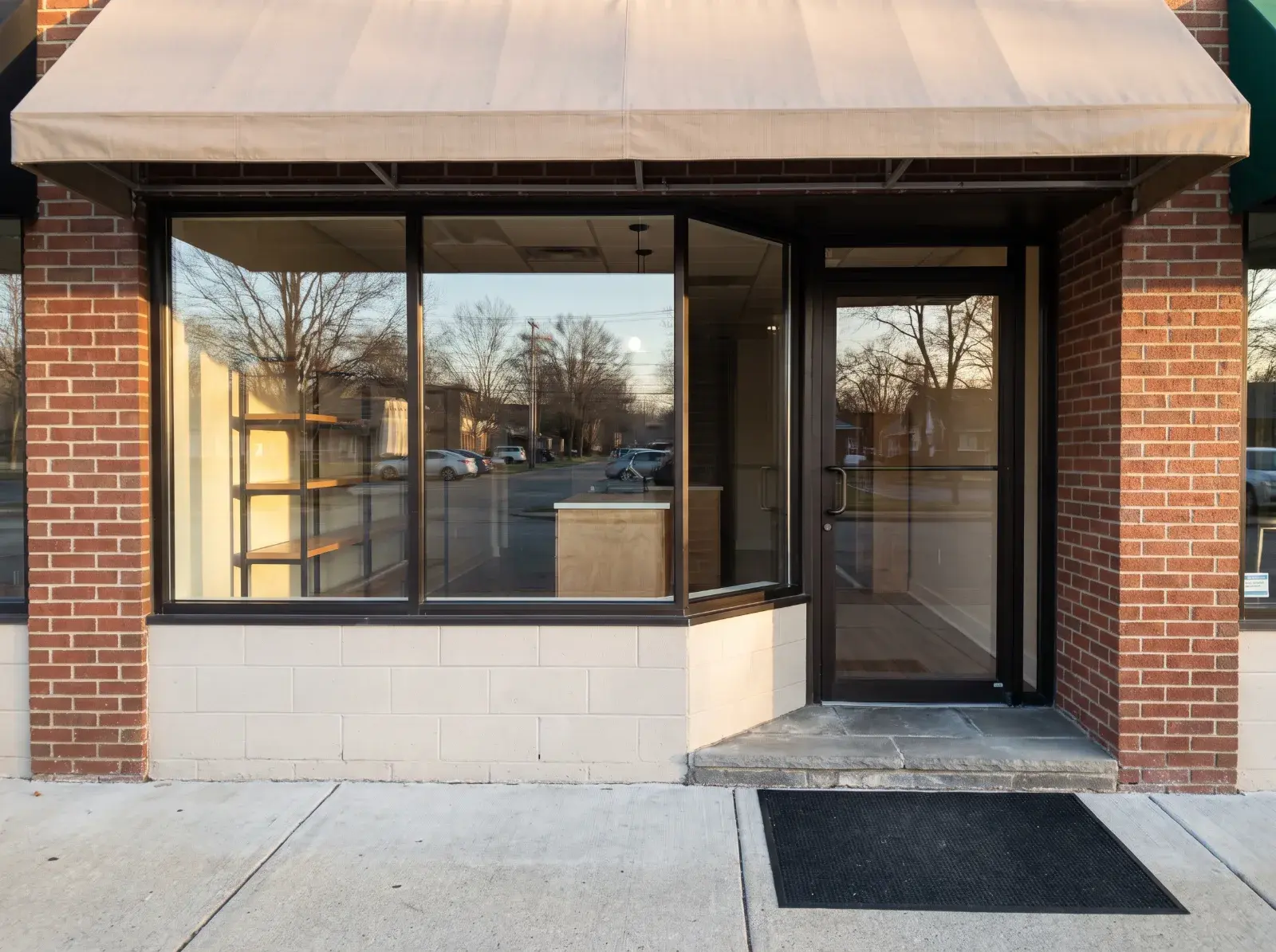 A small Columbus storefront with its window and door glass cleaned on both sides and the entry swept