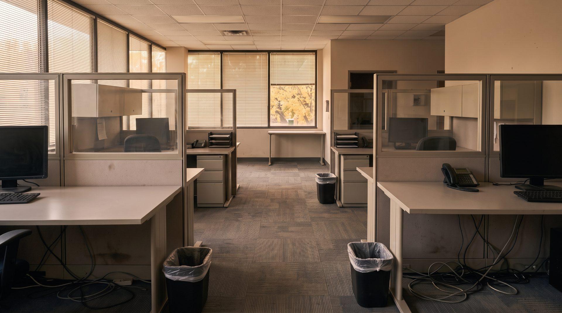 A cleaned small office with polished glass partitions and clear desks